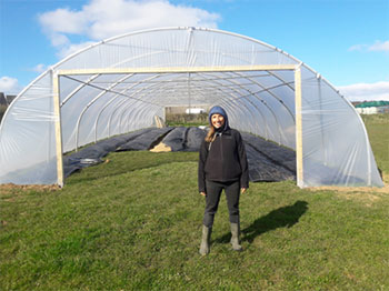 Abbi Mason with polytunnel