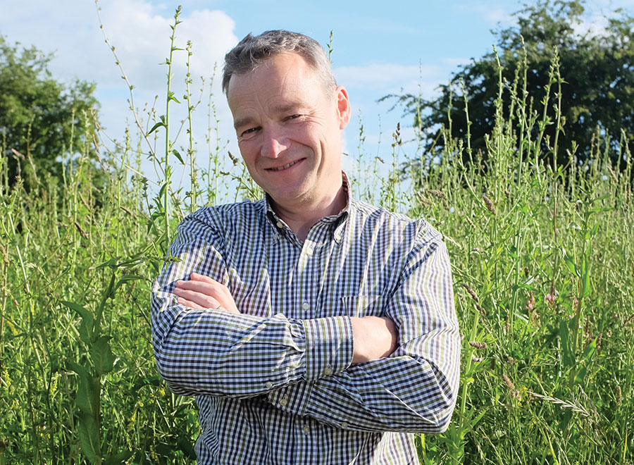 Ian Wilkinson standing in field