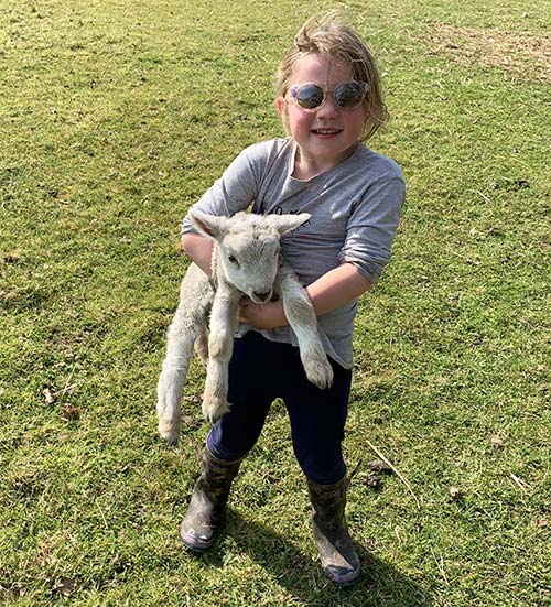 Olivia holding a lamb