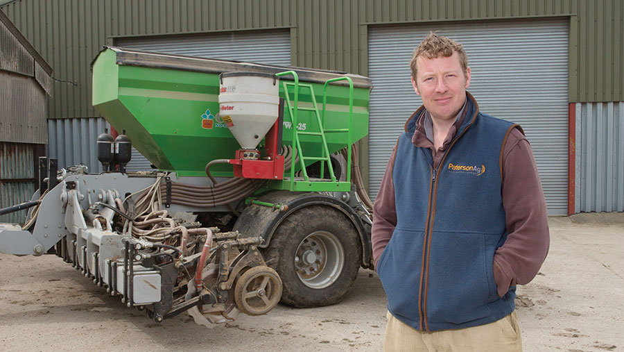 David Lord in front of farm machinery