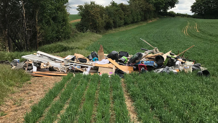 Fly-tipped waste in field