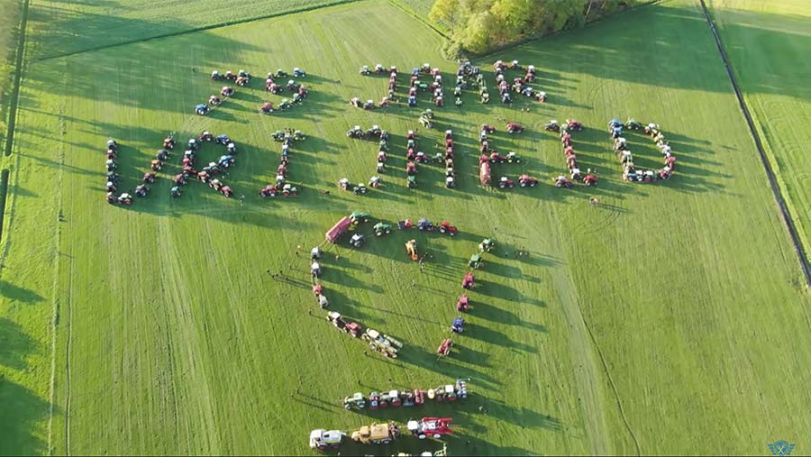 Tractors spelling out words in a field