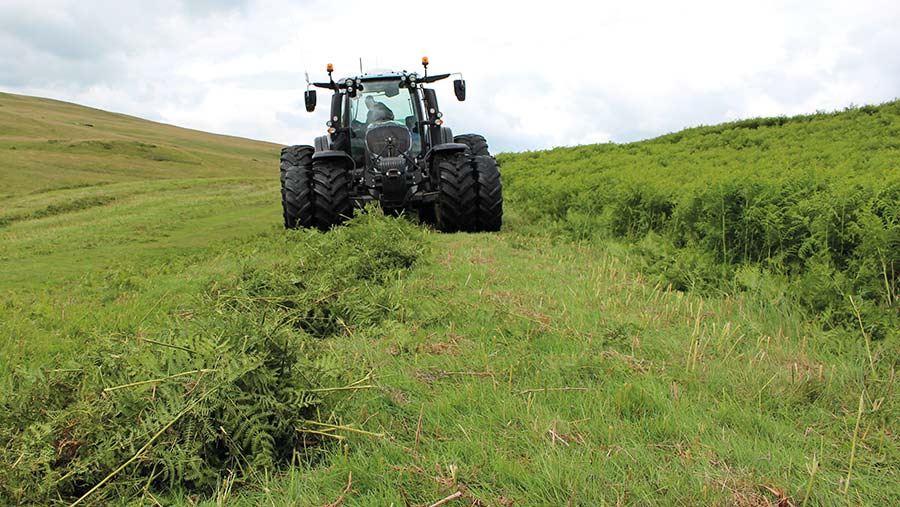 Tractor harvesting bracken