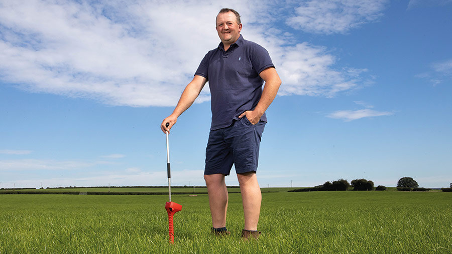 James Muir  in field with grass meter