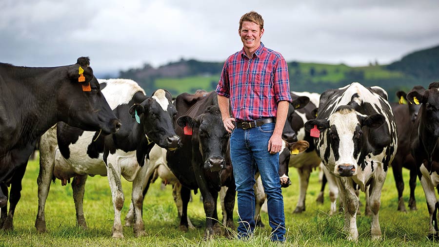 Sam Carey in field with cows