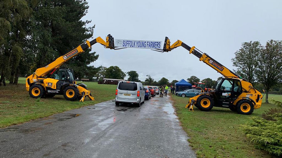 Two telehandlers with banner