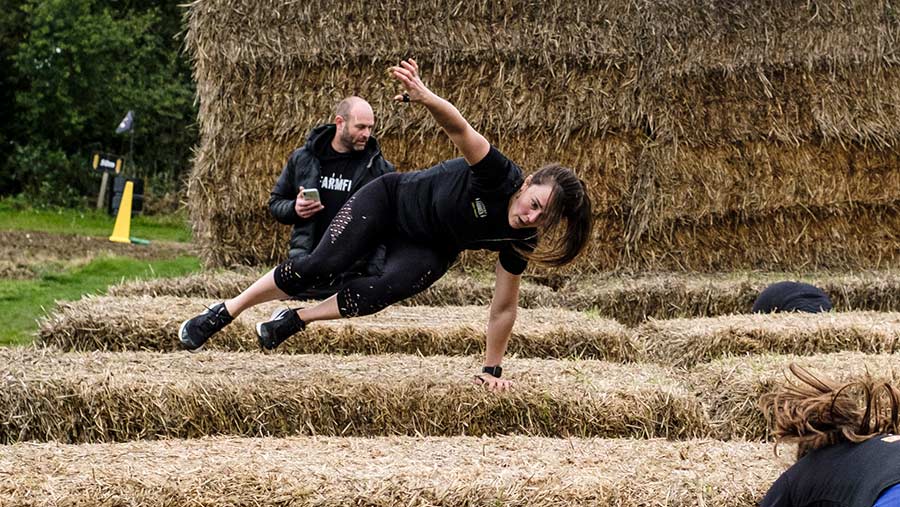 Britain's fittest Farmer 2020 winner Emma Ashley leaps over a bale © Colin Miller/MAG