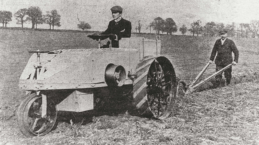 Dan Albone driving one of his Ivel tractors pulling a plough