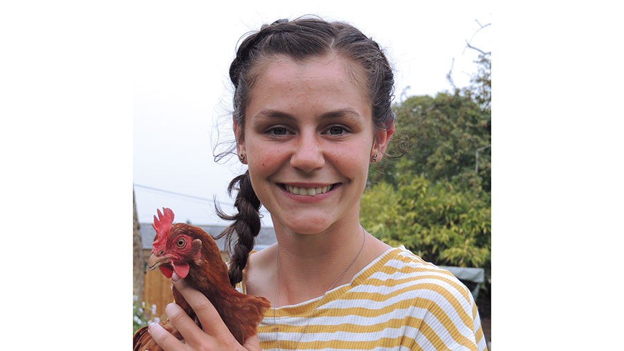 Jess Palmer holding a chicken