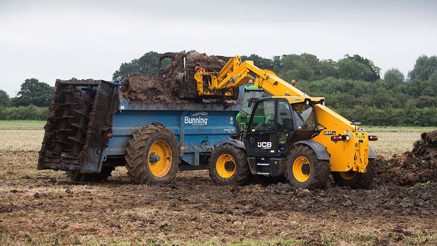 Contractors spreading farmyard manure