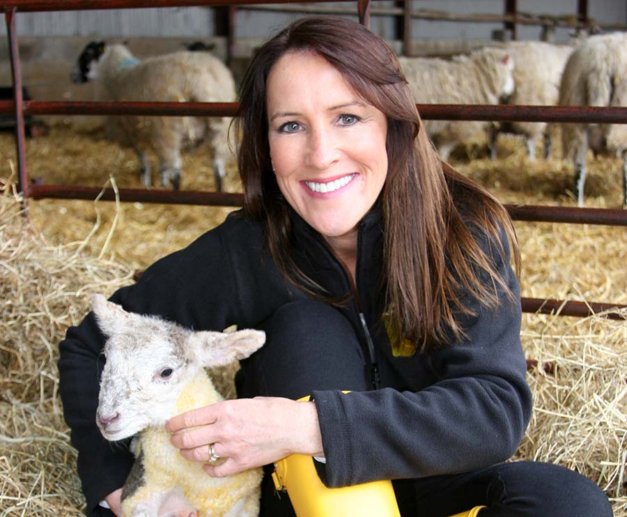 Stephanie Berkeley with a lamb