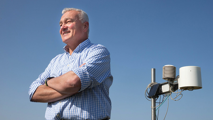 Nick Padwick next to weather station