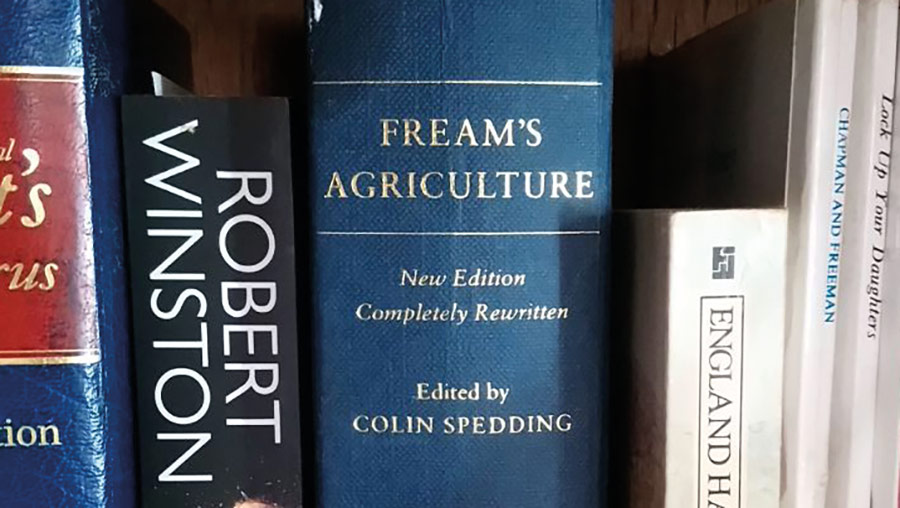 Books on a bookshelf, including Fream's Agriculture