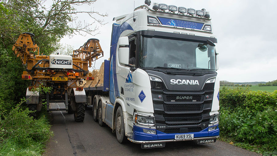 The narrow Langley Bush Road with two large vehicles