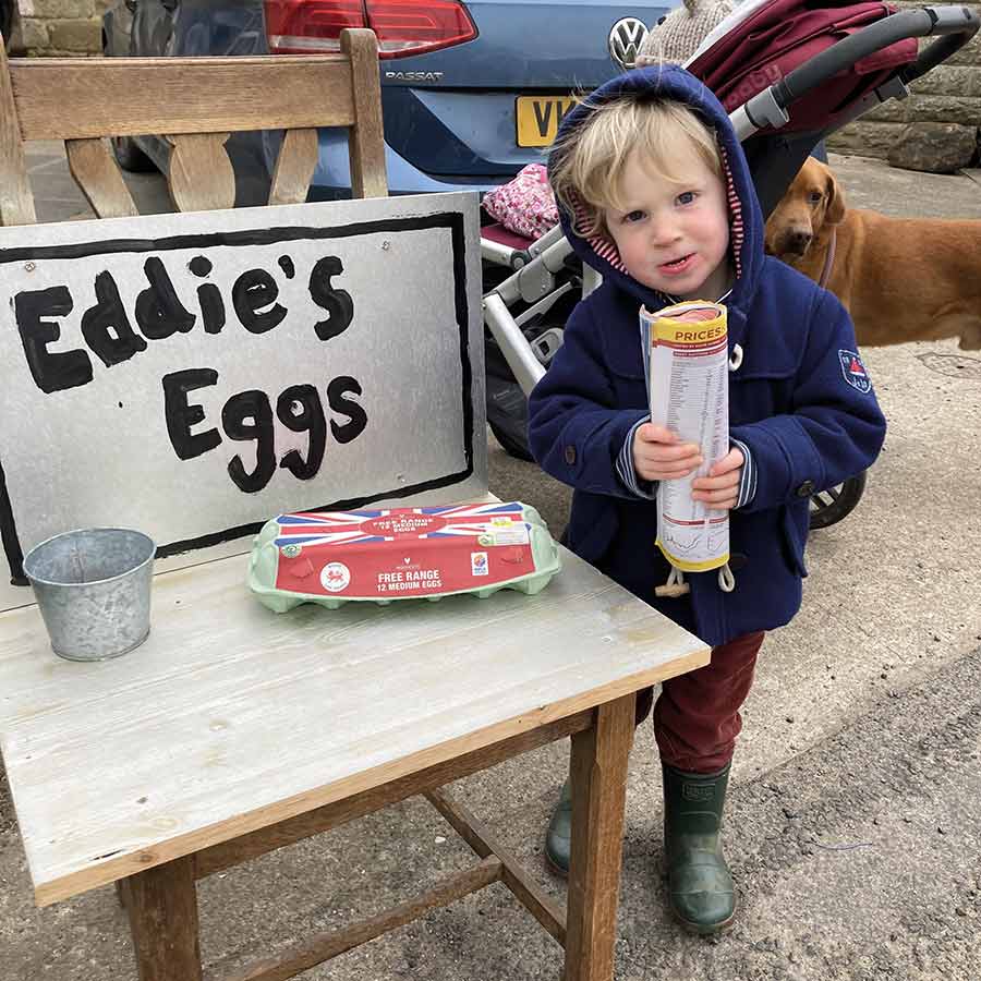 Boy with egg sale sign