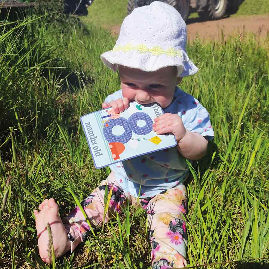 Girl with card in gras