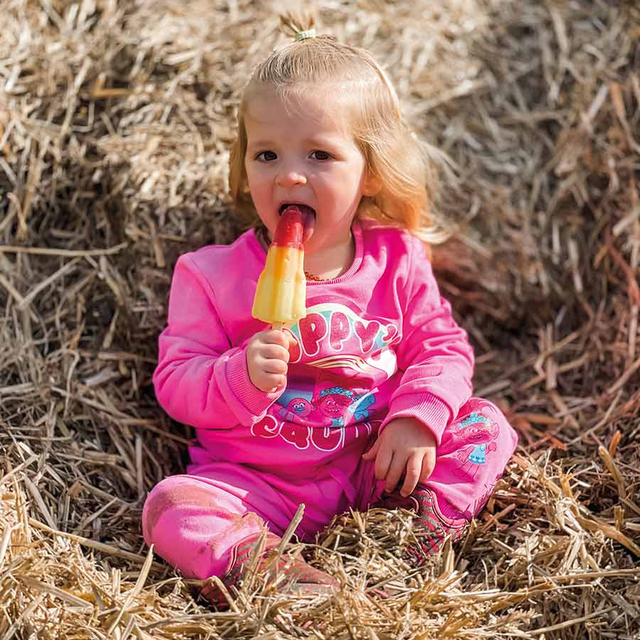 Girl in hay with ice lolly