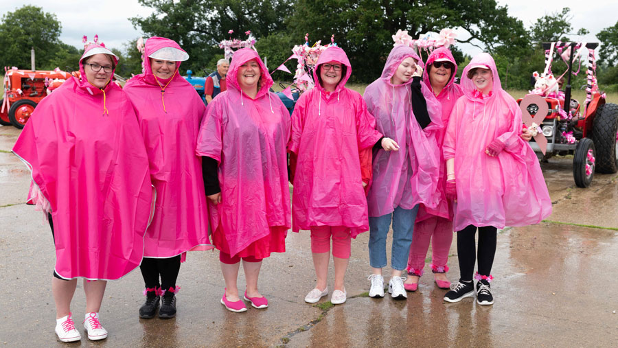 Family in pink raincoats