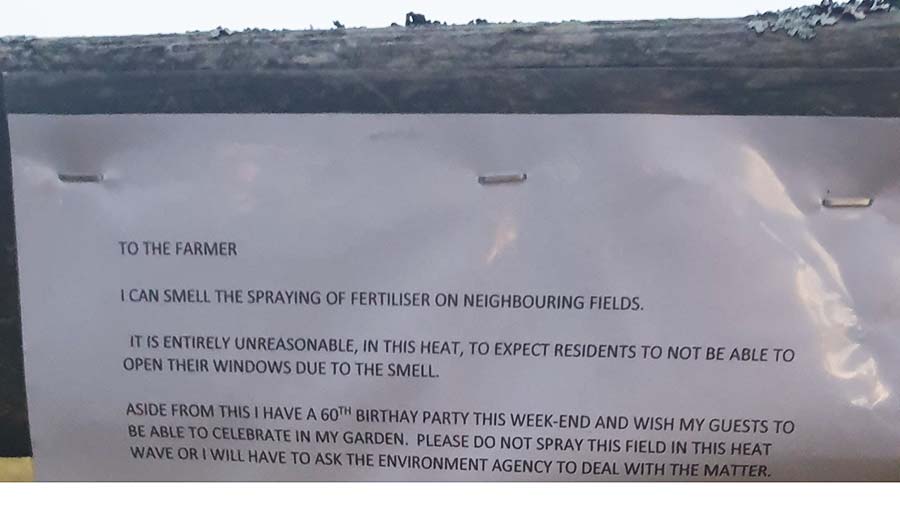A photo of the note stapled to a gate