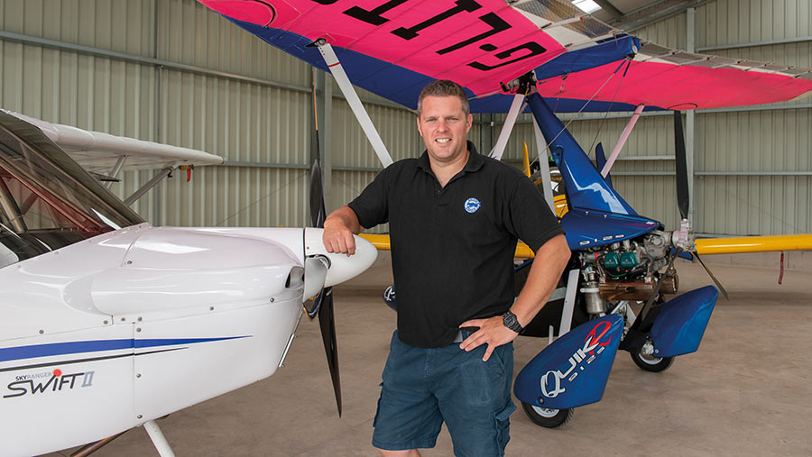 Man leans on the propellor of a light aircraft