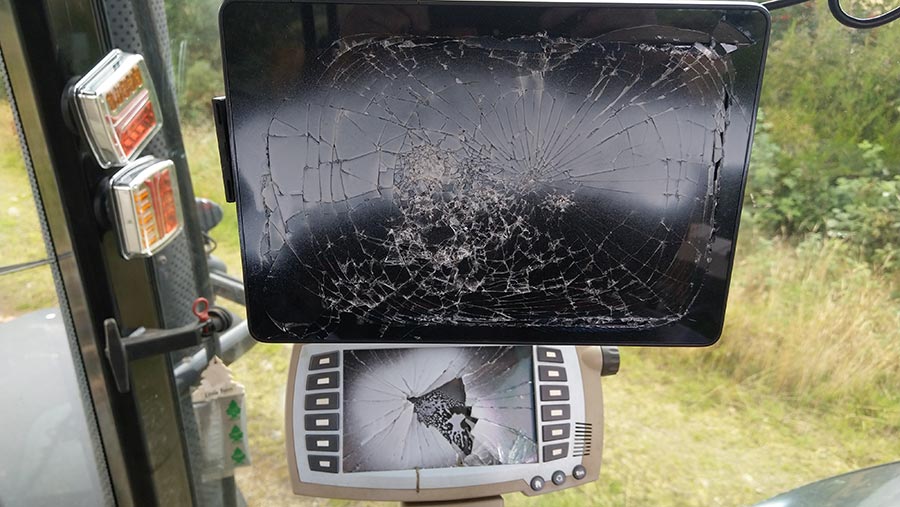 Smashed touchscreens inside damaged tractor