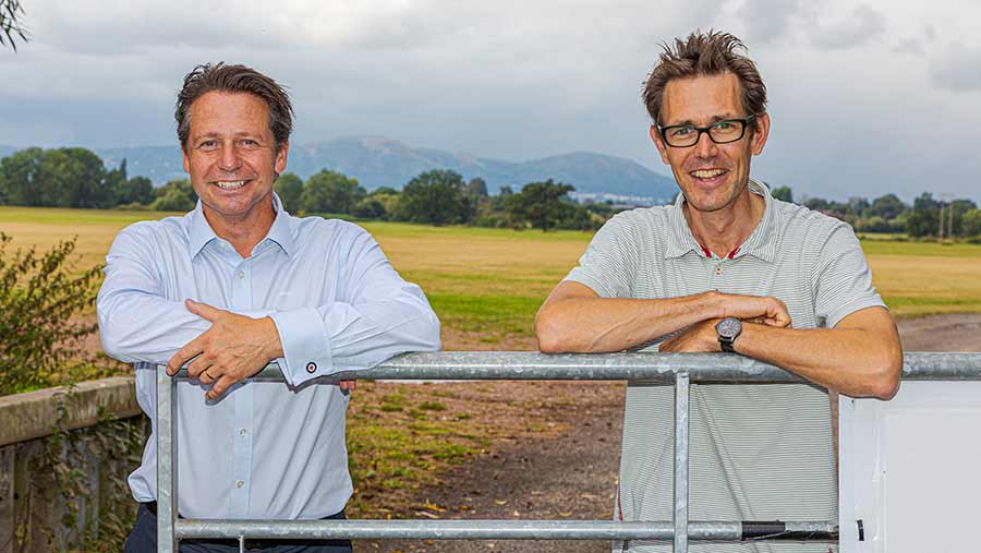 Two men lead on a farm gate