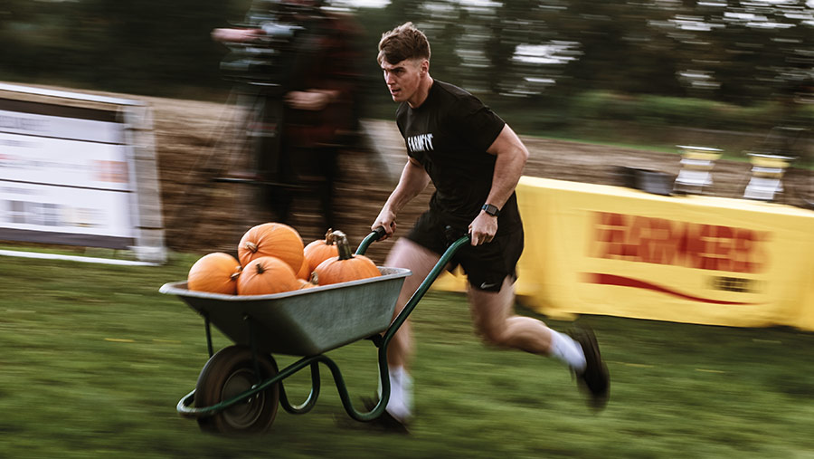 James Arney pushing a wheelbarrow