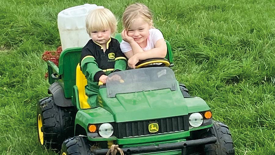 Lizzie and Alice Crowther in toy tractor