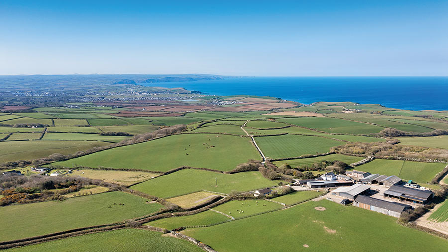 Aerial view of farmland with the sea in the distance