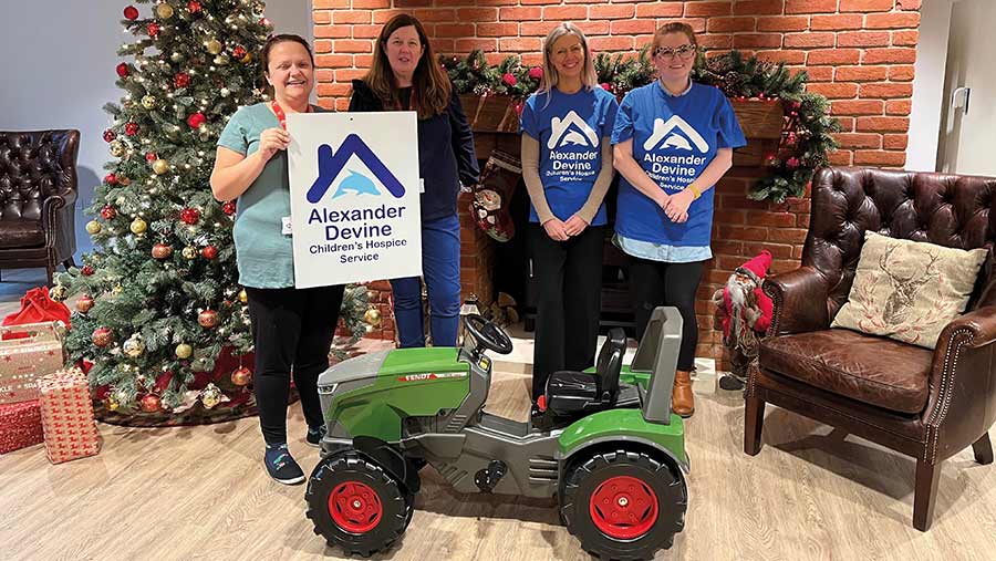 Toy tractor being given to Alexander Devine Children’s Hospice Service