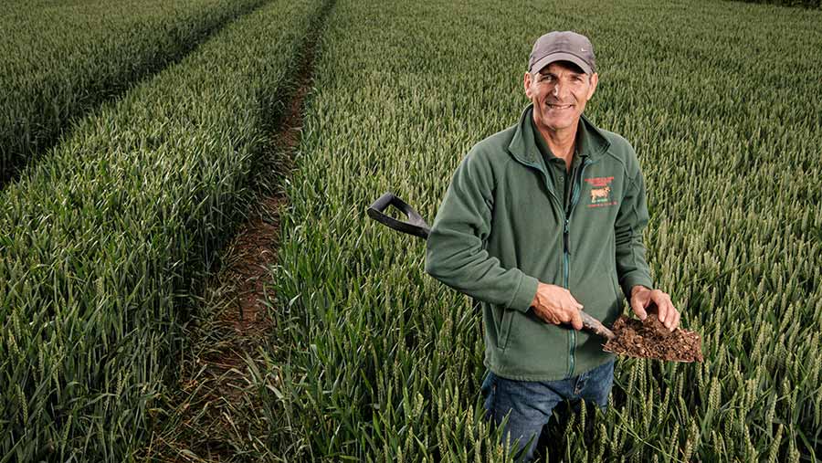 Paul Temple in field with spade