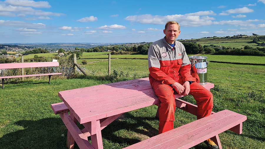 Eddie Andrew sitting on pink picnic table