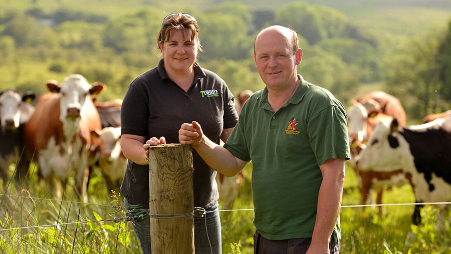 Sarah and William Haire  in field with cows