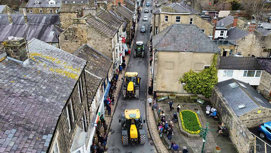 Drone view of town street with tractors