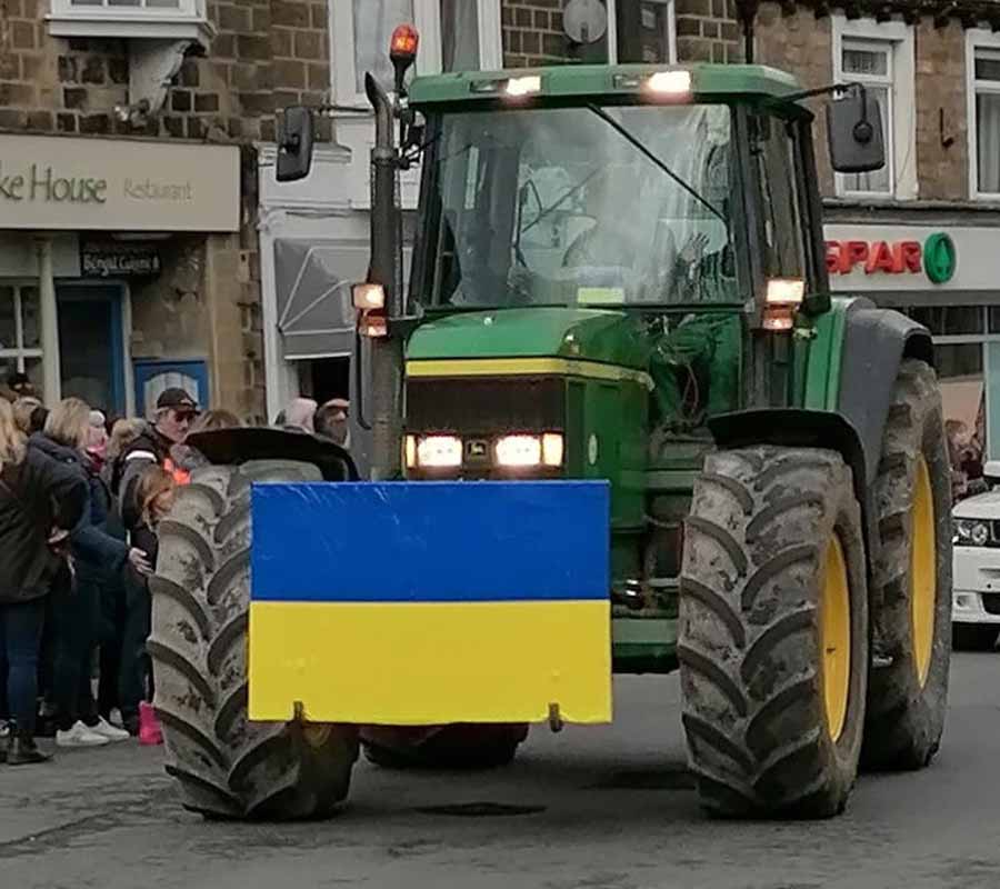 Tractor with a Ukrainian flag on the front