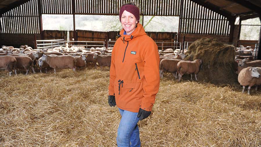 Bryony Gittins in a shed with sheep