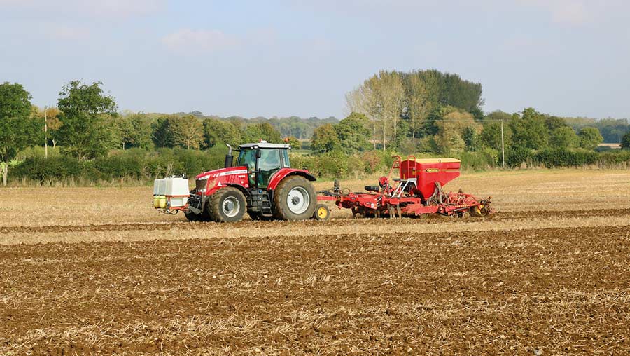 Tractor pulling a seed drill