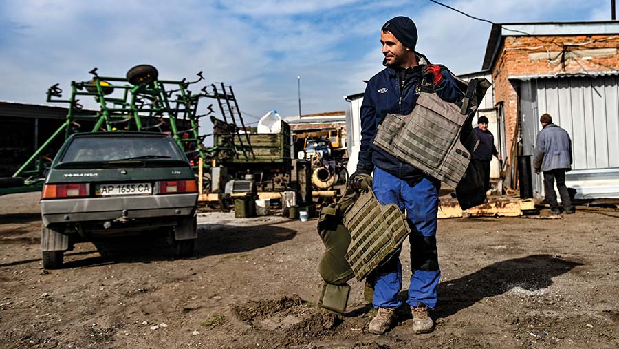 UkrUkrainian farmer carrying bulletproof vest