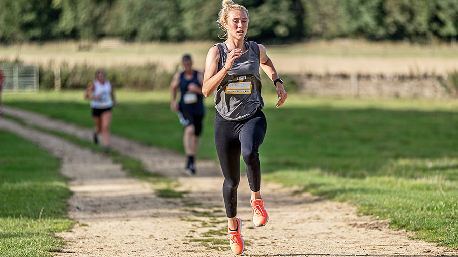 A female contestant running in the Britain's Fittest Farmer 2021 semi-final heats 