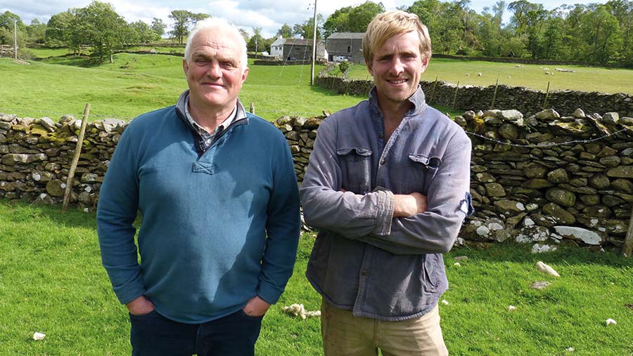 Two men in front of a dry stone wall