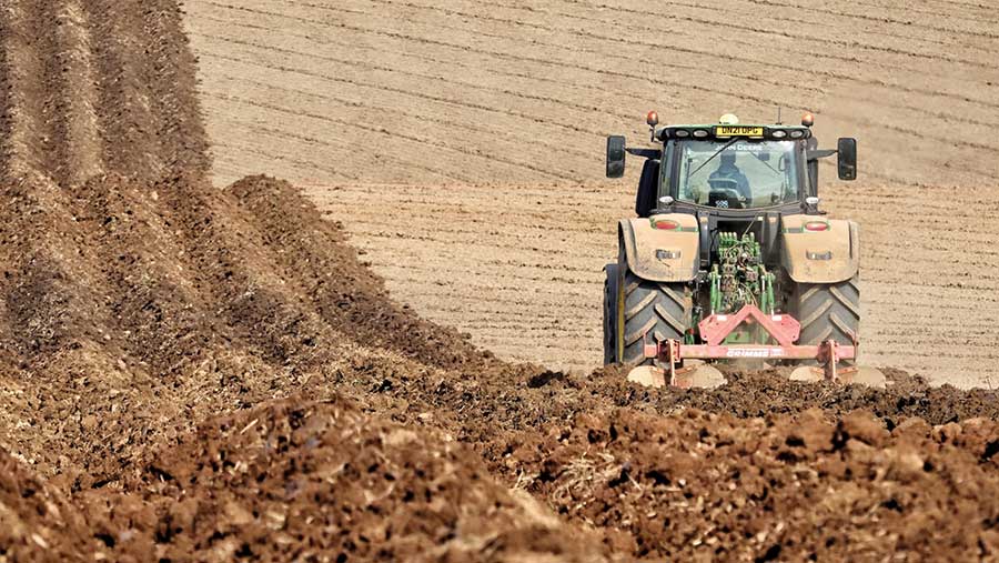 Tractor in field potato planting in May