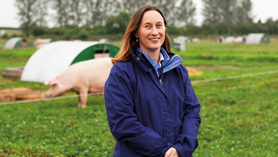 Zoe Davies with pigs in background