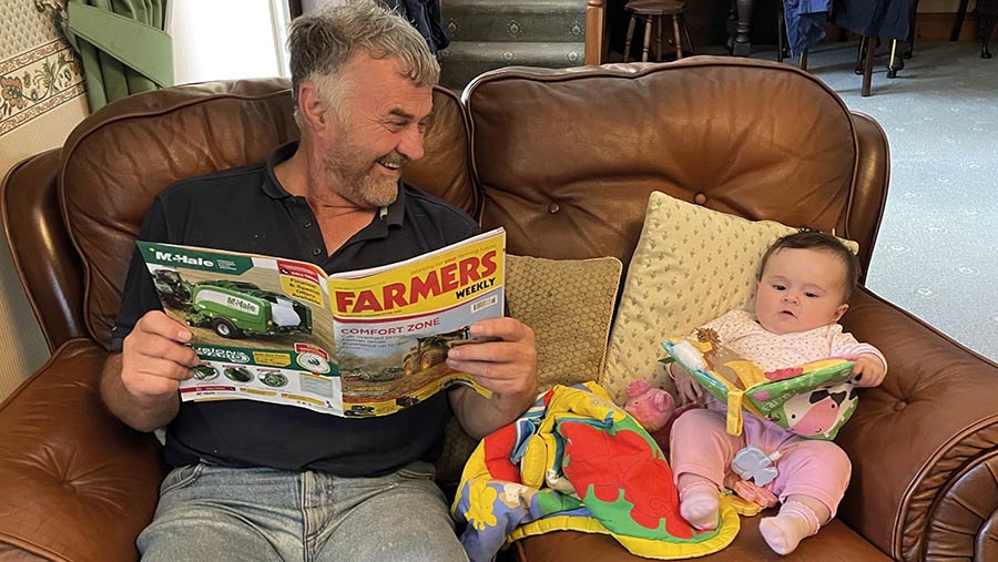 Gwenlli and her grandfather reading Farmers Weekly