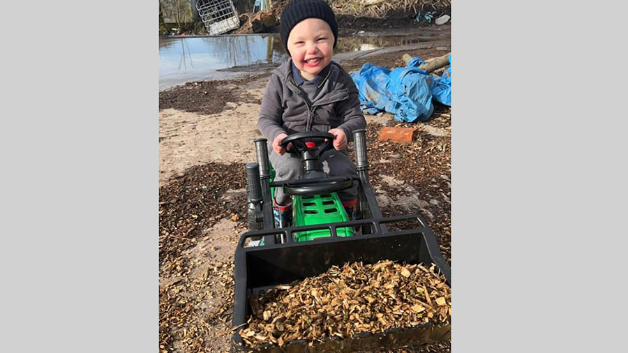 Albie Speakman on a toy digger