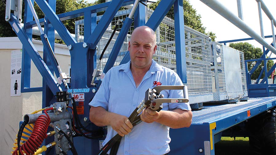 Phillip Rees of M4 Trailers shows the hydraulic hose quick coupling device for his load securing trailer