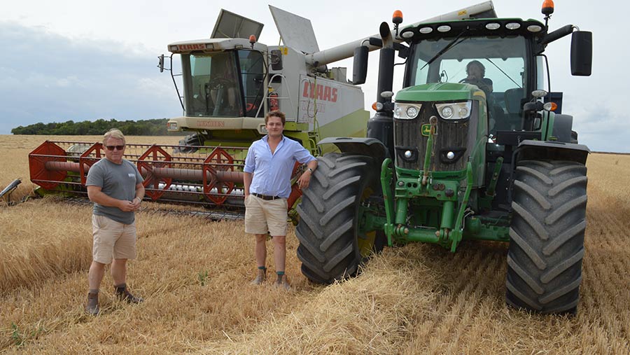 Robert Todd and Charlie Todd with tractor and combine in spring barley field