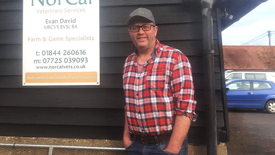 Man standing in front of a shed