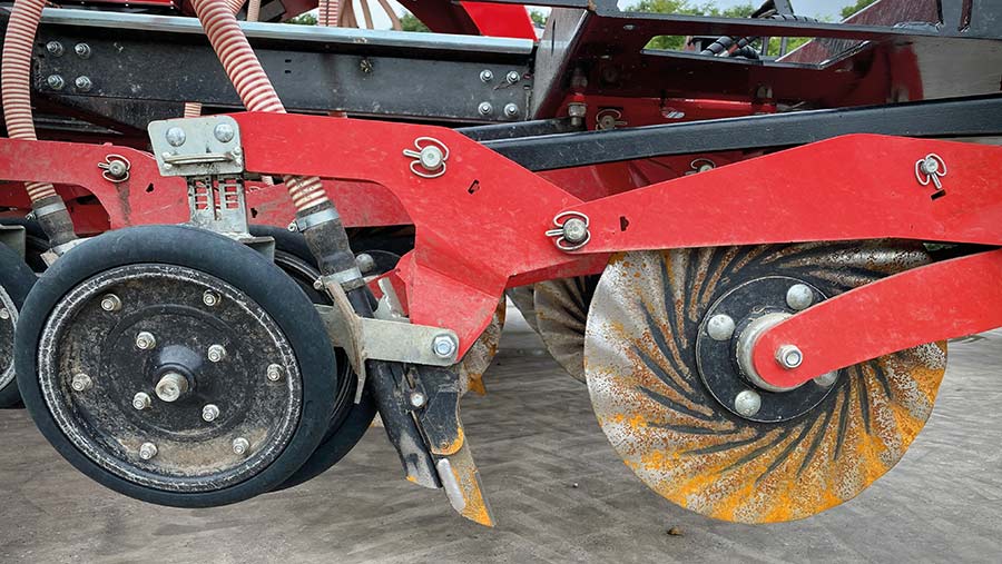 Side view of coulter, tine, seed outlet and rubber wheel