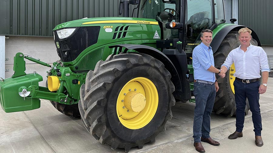 Ben Turner (left) with Ian Double day  in front of a John Deere 6R 155 tractor