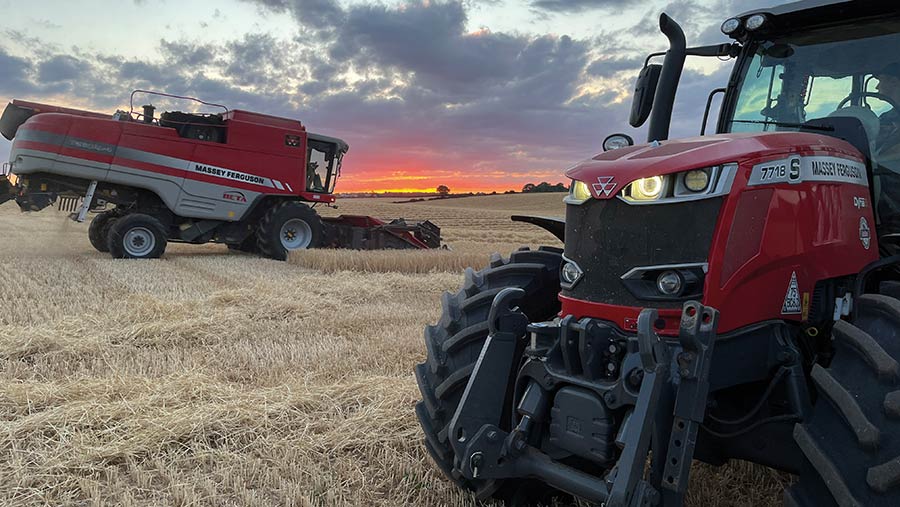 Sun setting in field behind machinery in field